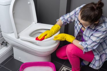 Removing urine stains from a toilet seat.