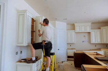 Adjusting old cabinet doors in the kitchen.