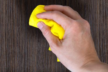 Cleaning and polishing a wooden door (wood door maintenance).