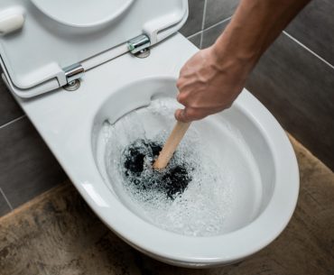 Plugged toilet. Brown toilet water.