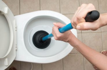 Using a plunger to unclog the toilet
