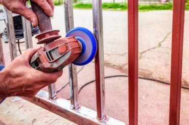 Using and angle grinder to remove paint from metal.