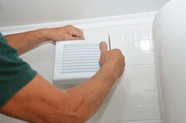 Repairing a noisy bathroom exhaust fan (ventilation).