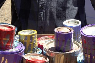 Disposing of old paint and cans. Taking paint cans to a recycling center.
