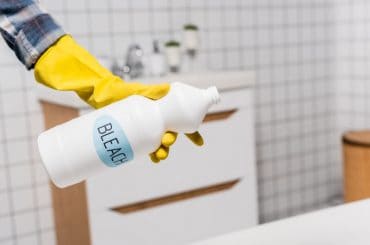 Getting rid of old bleach and container.