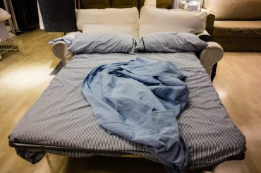 Using a sofa as a temporary guest bed.