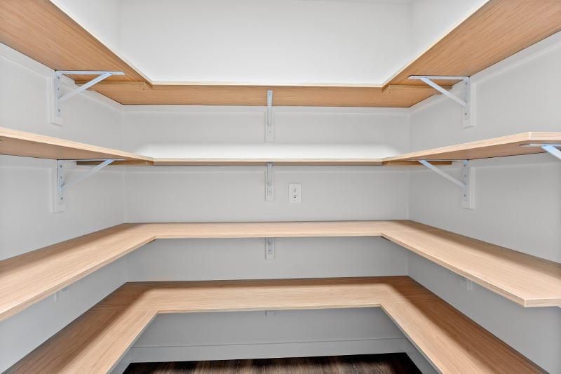 Empty wooden pantry shelves.