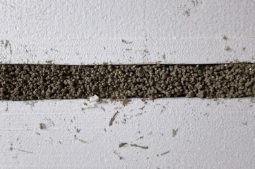 EPS concrete made from EPS beads, cement and water for covering pipes and cables.