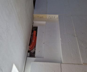 EPS 100 rigid insulation boards installed on a prepared floor base, providing thermal insulation and load support beneath the concrete slab.