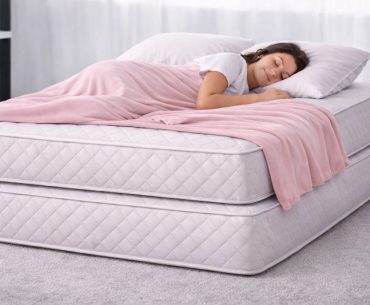 Young woman sleeping on two mattresses that are stacked one on top of the other.