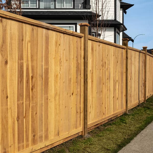 A dense, gap-free wooden fence that helps reduce traffic noise and block unwanted views.
